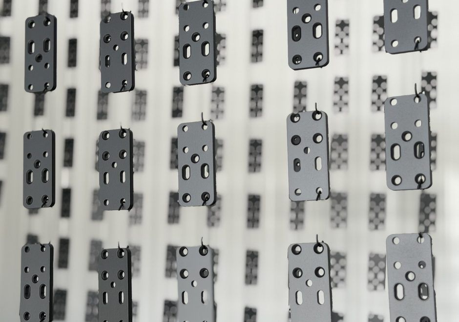 Hang line loaded with repeat hardware parts for powder coating